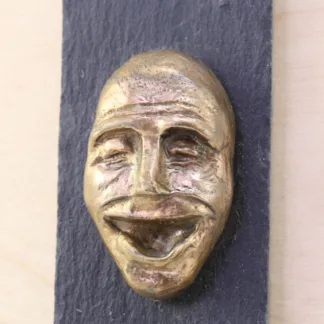 Glad ansigt - Bronzefigur